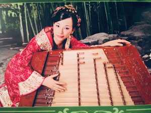 Dr. Wenzhuo Zhang with a traditional Chinese instrument, the yangquin