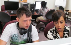 Ms. Skemer helps Patrick with his financial aid in our computer lab.