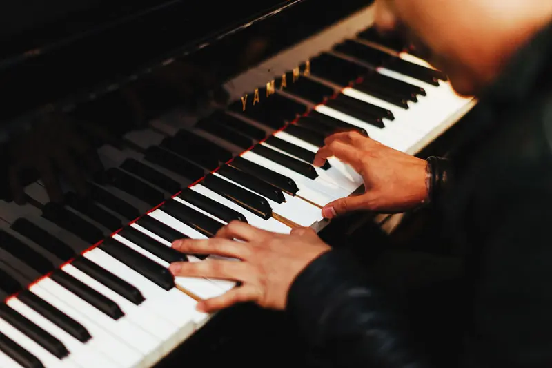 photo of hands on a piano keyboard