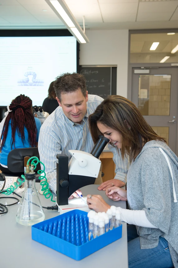 Biology Professor Scott Ferguson works with a student in a lab.