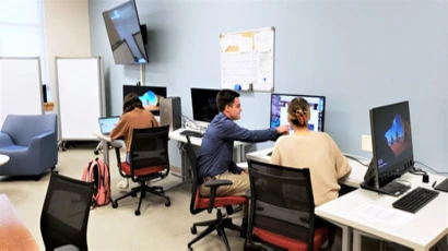 Interns working at computers in Innovation Design Studio