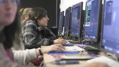 An animation student works on a computer during class, working towards bachelors degree in animation and illustration.
