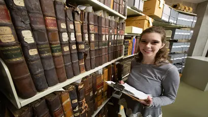 A Fredonia student looking for answers in the archives. Major in history, jobs for a history major, history major, degree in history.