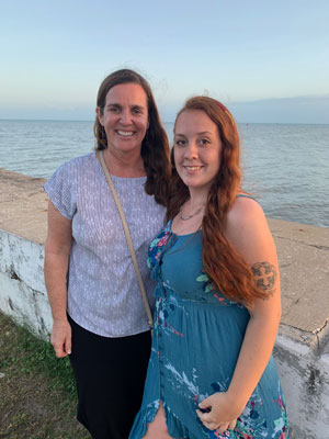 faculty member and student on beach in Belize