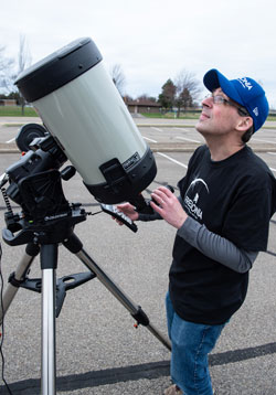 Eclipse Planning Committee Co-chair Michael Dunham with a portable Celestron telescope equipped with a computerized mount. It was used with a solar filter to view a magnified image of the partially eclipsed sun.