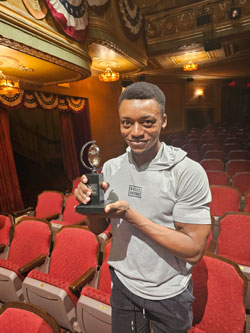 Alex Grayson holding TONY Award