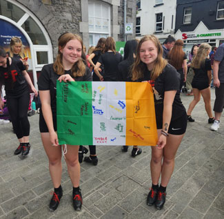 dancers displaying flag