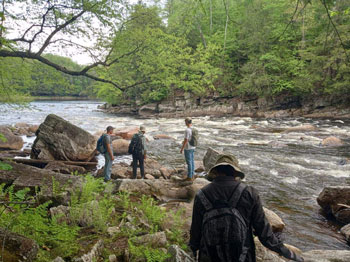 student in the field doing research