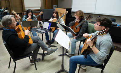 Professor Piorkowski rehearses with students.