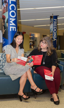 Makayla Barone, a junior from Buffalo, reviews Aldine Independent School District brochures with Debra Karpinske-Keyser, director of the Office of Field Experiences.