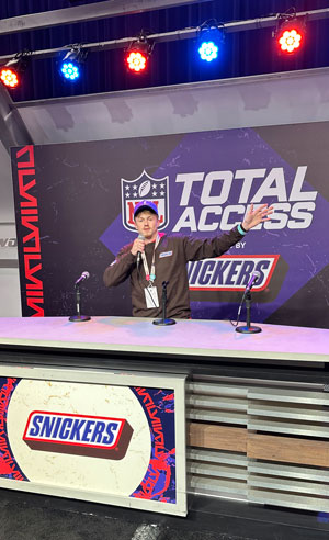 Ian Summerson, a senior Sport Management major from North Tonawanda, NY, at the Total Access booth in the Super Bowl Experience.