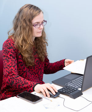 Vanessa Ryhal, a senior Public Accountancy major from Cameron, NY, reviews a tax form.