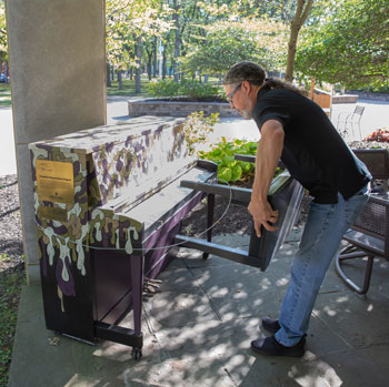 person setting up piano on patio