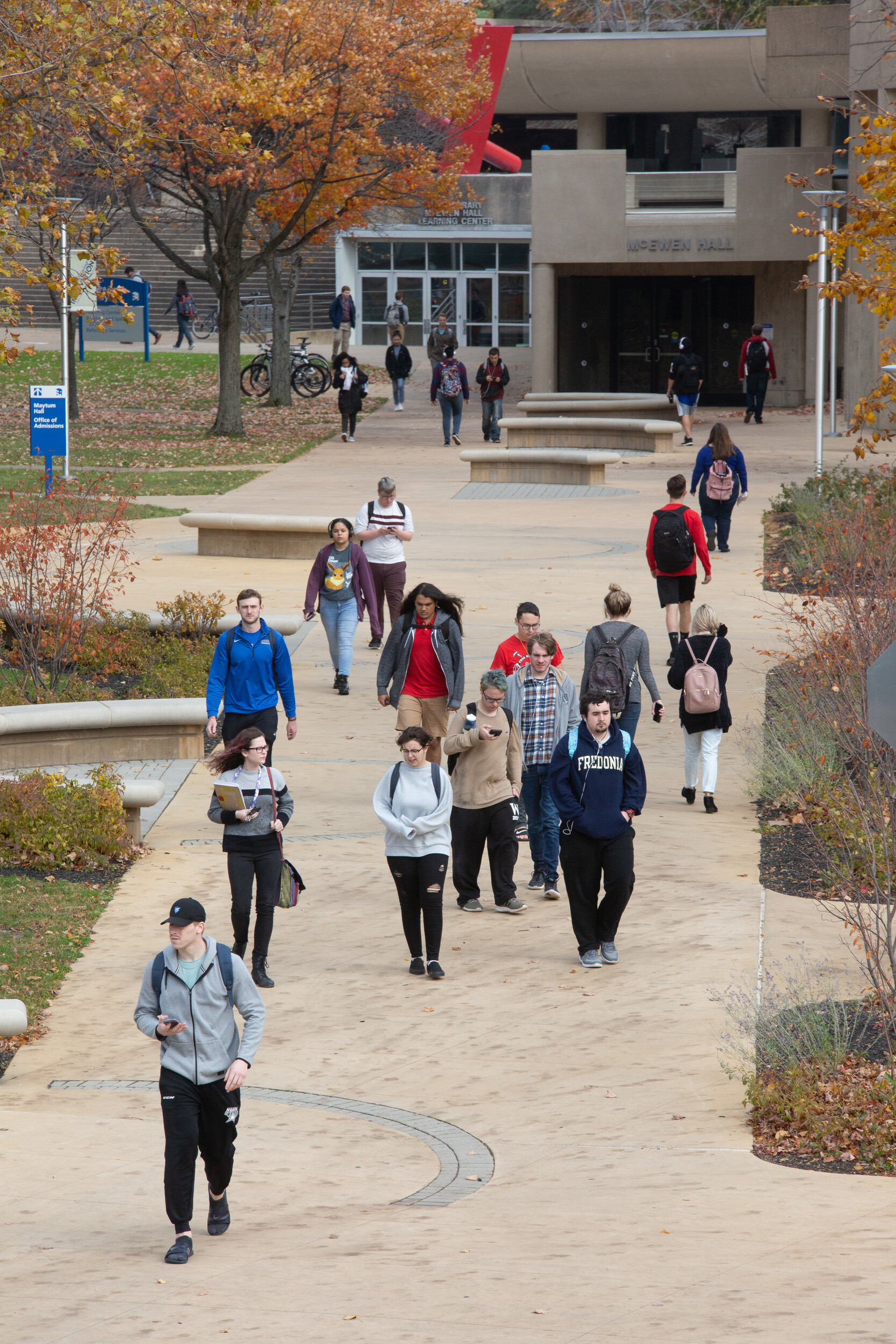 students walking across campus on a crisp fall day.