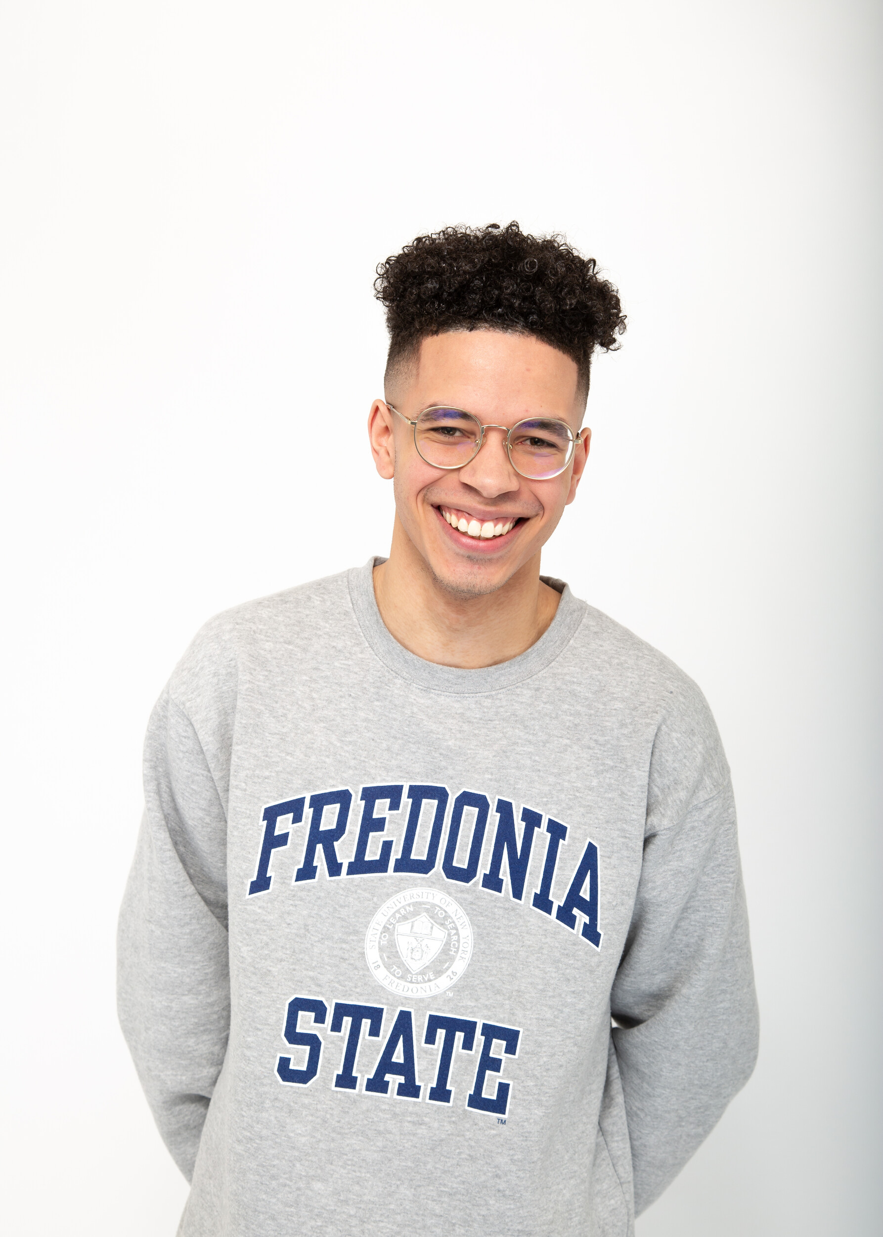 Featured student Thomas poses on campus