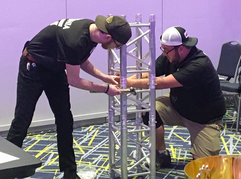 Christian Pearson (left) and Franklin Krzyzewski participate in the Tech Olympics rigging challenge. 