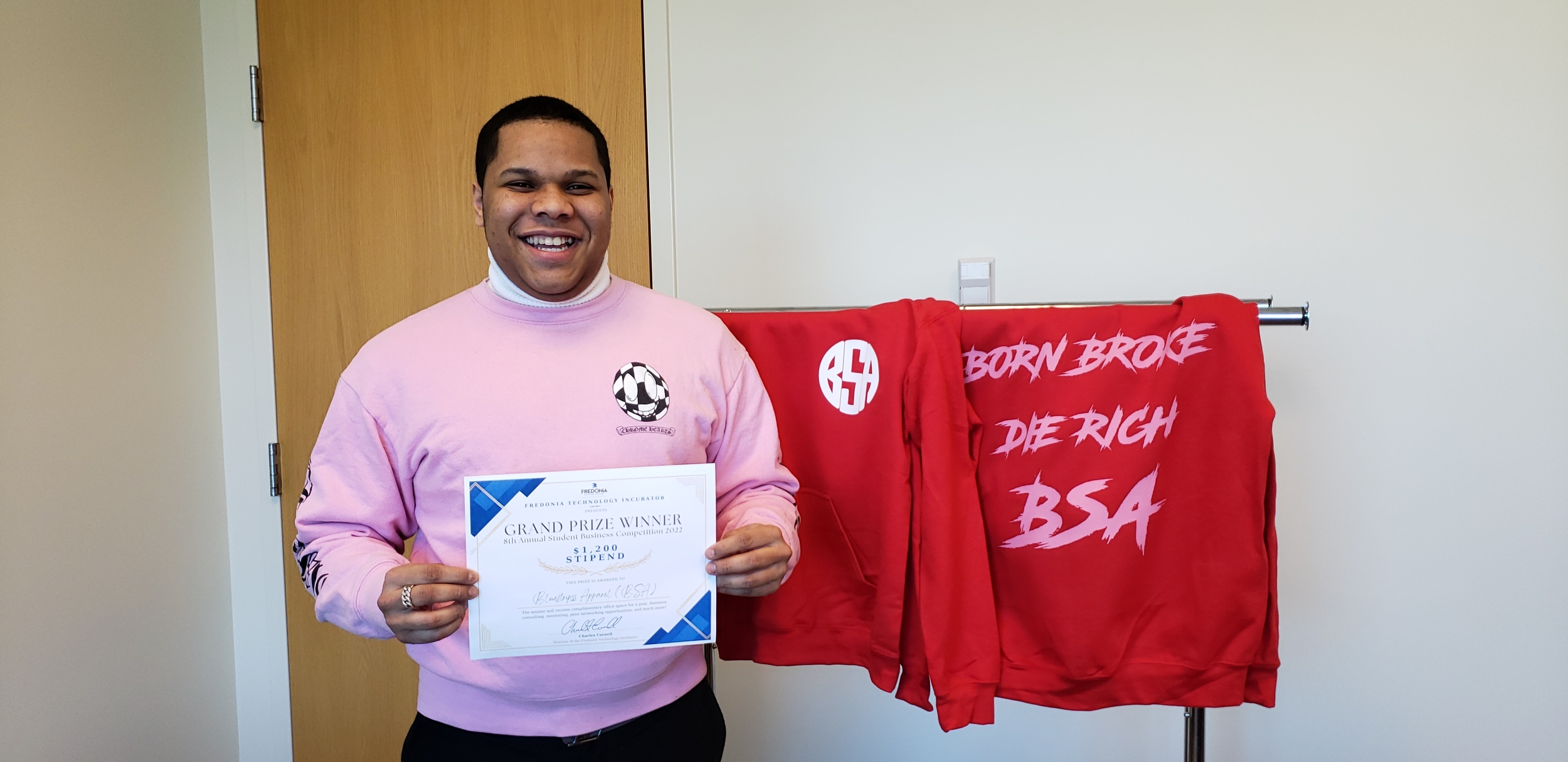 SBC Fall 2022 Winner posing with certificate next his company's apparel