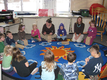 Elementary student teacher from SUNY Fredonia at circle time with students.