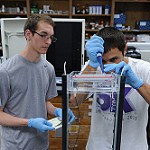Two Students Performing an Experiment