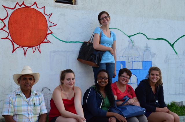 students in front children mural in oaxaca