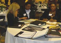 Sue, Ida, and Gwen look over the scrapbooks from their years at Fredonia