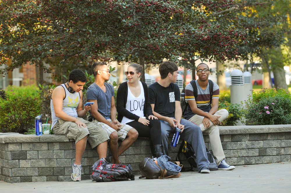 Students gather at University Commons in the evening.