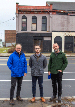 researchers standing next to buildings