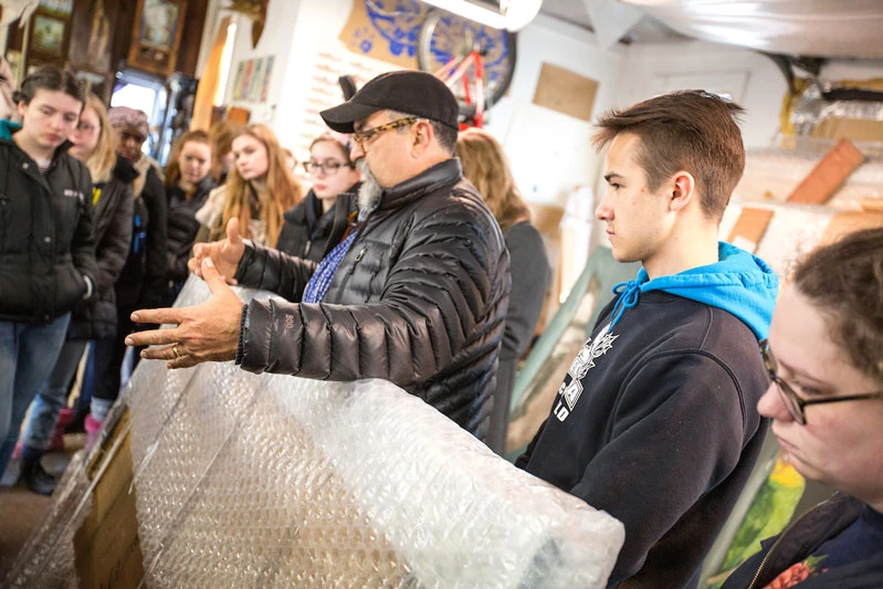 SUNY Distinguished Teaching Professor Emeritus Alberto Rey, with students in his art studio.