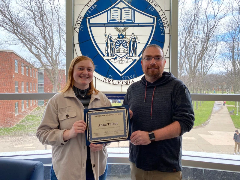 Anna Talbot and Tylor Cardone, of the ITS Service Center, display her certificate of achievement upon being named Student of the Month.