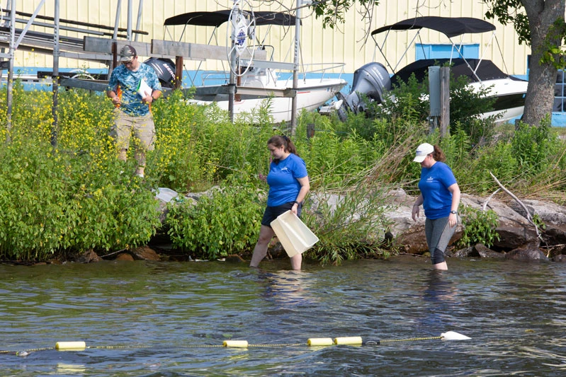 Dr. Courtney Wigdahl-Perry joins Kasey Crandall and Madison Miller in collecting water samples in Chautauqua Lake in the summer of 2021