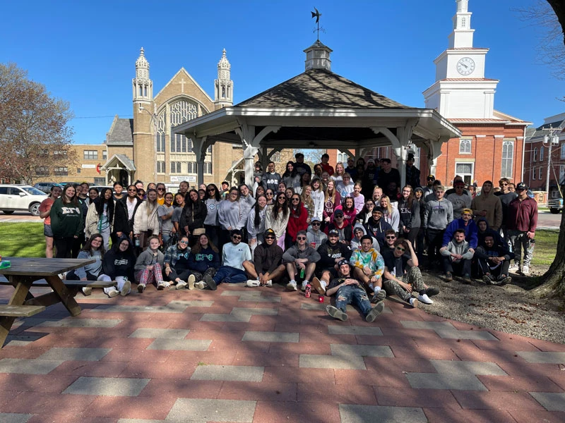 students gather in front of gazebo in park