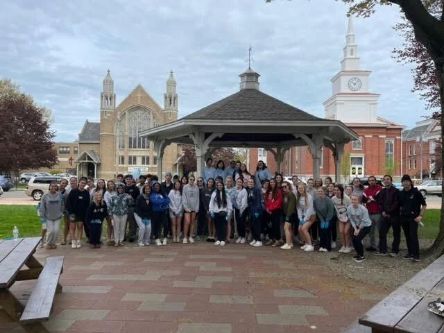 students gather in front of gazebo in park