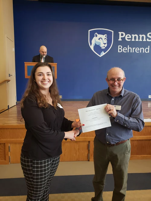 Sadie Olrogg receives a first-place award certificate from Jay Amicangelo, NWPA Sigma Xi chapter president.