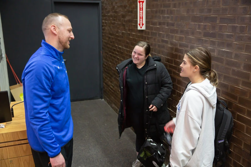 Scott Bergen talks to two students after a class talk he gave.