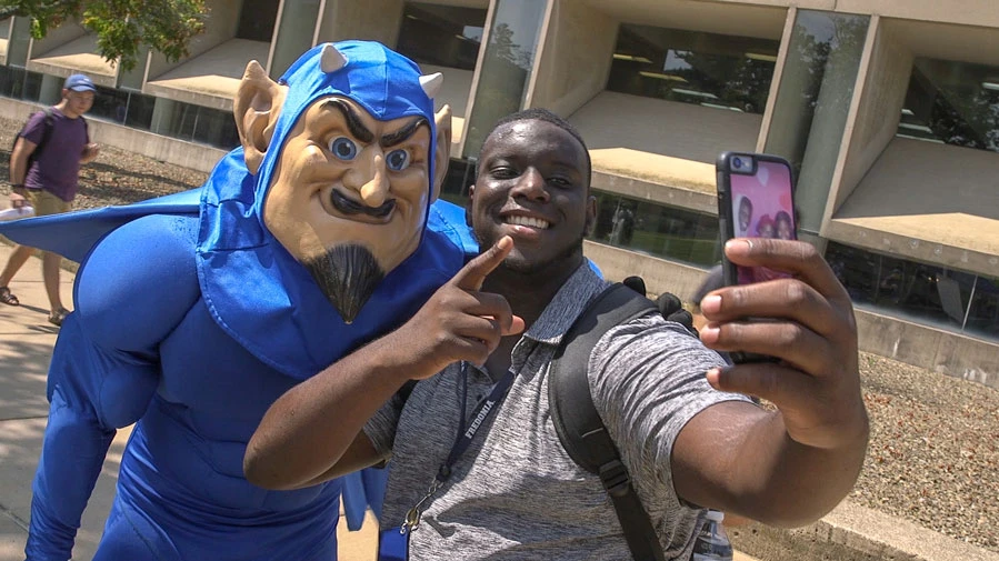student with Blue Devil mascot