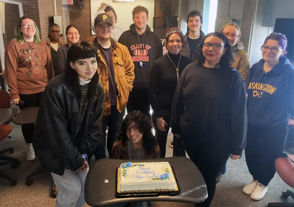 Gathering around a birthday cake served during a visit to the Stefan Zweig archive in Reed Library are students enrolled in the course ENGL 213: Texts & Contexts.
