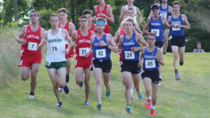 The men descend a hill at the 2019 Fredonia State Invitational (photo by Megan Moellendorf)