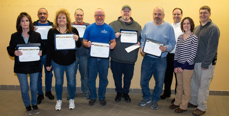 Staff displaying their Custodial Safety Incentive Award certificates