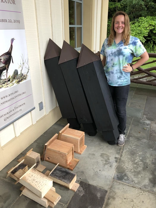 Jessica Schimek, with completed bee blocks, squirrel nests and bat houses 