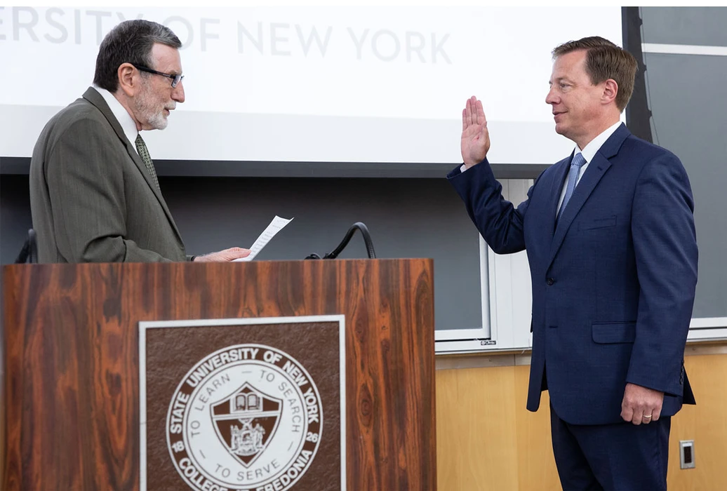 Brent S. Isaacson is sworn in as Chief of University Police by Fredonia Interim President Dennis Hefner.