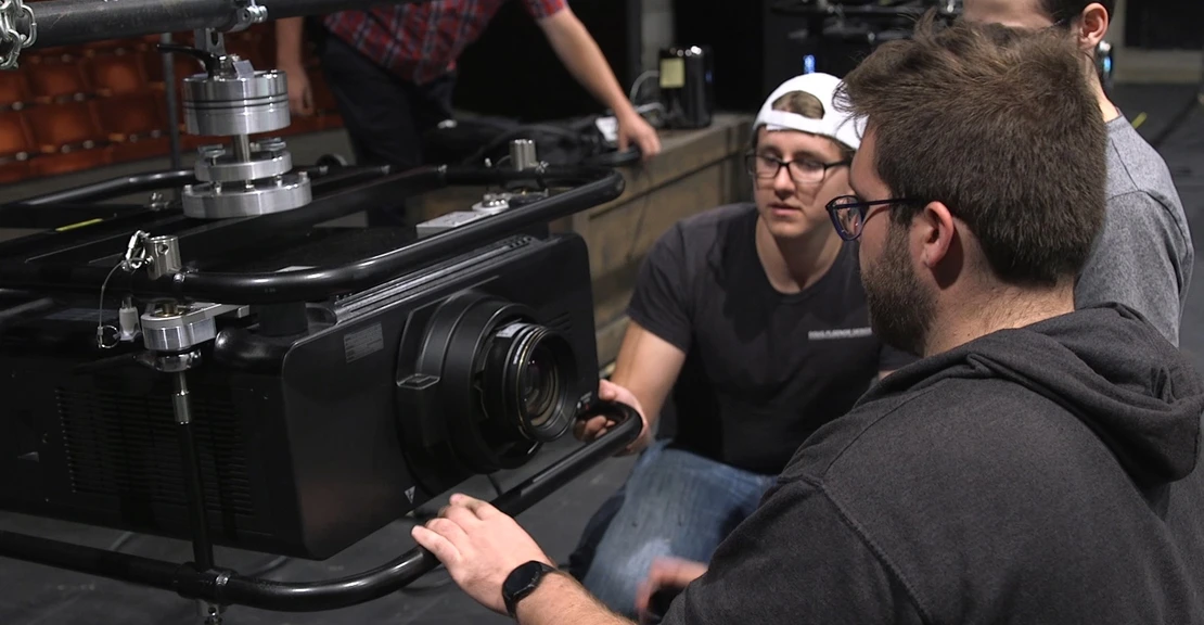 College of Visual and Performing Arts students set up one of the new projectors in Marvel Theatre.