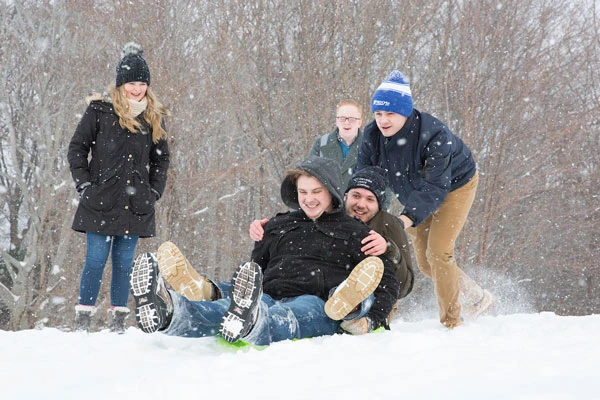 students snow sledding