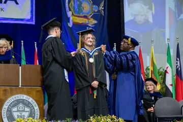 Mia Piede receives Lanford Presidential Prize medallion from President Kolison