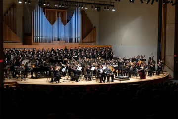 orchestra and chorus performing on stage in King Concert Hall