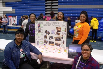 students with poster at Activities Night in Steele Hall