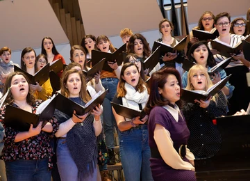 students singing in King Concert hall with accompanist