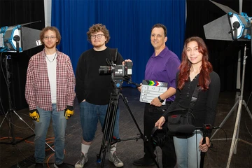 Nicholas Smith (second from right), with his student crew (from left) Anthony Derby, Conor Clary and Samantha Zotara in the McEwen Hall film studio.