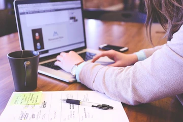 image of student working on laptop