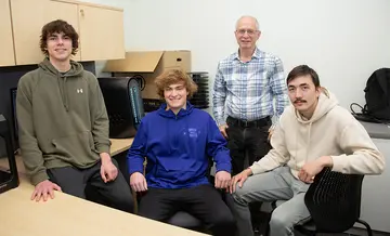 SUNY Fredonia students who participated in the Consortium for Computing Sciences in Colleges Northeast Region, with Dr. Ziya Arnavut (standing) were (from left): Landers M. Sanchez, Tyler J. Ferrari and Alim A. Darmenov.
