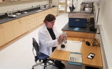 Alumnus Joli Springborn using a Konica-Minolta CR-400 colorimeter to precisely determine the color of geological specimens.